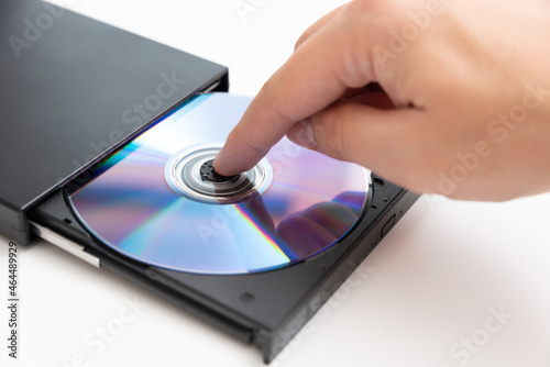 External DVD drive reader, man putting disc photo