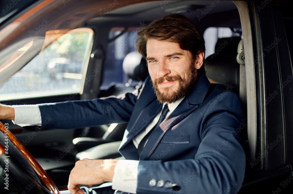 bearded man Driving a car trip luxury lifestyle success service rich