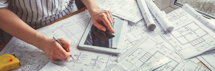 Architect works remotely from home in quarantine, lockdown covid 19 coronavirus. Remote work, stay home, new normality, social distance. Architect design working drawing sketch plans blueprints