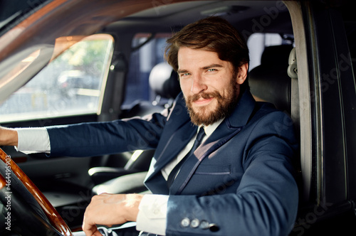 bearded man Driving a car trip luxury lifestyle success service rich