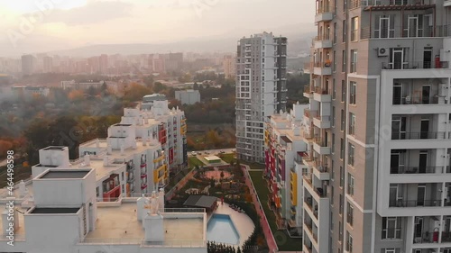 Tbilisi, Georgia - 17th october, 2021: Green diamond apartments complex buildings panorama with sunny sunset background. Georgia real estate property business industry concept photo