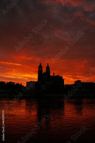 Silhouette of a medieval castle at beautiful bloody sunset at historical downtown of Magdeburg  old town  Elbe river and Magnificent Cathedral  Germany.