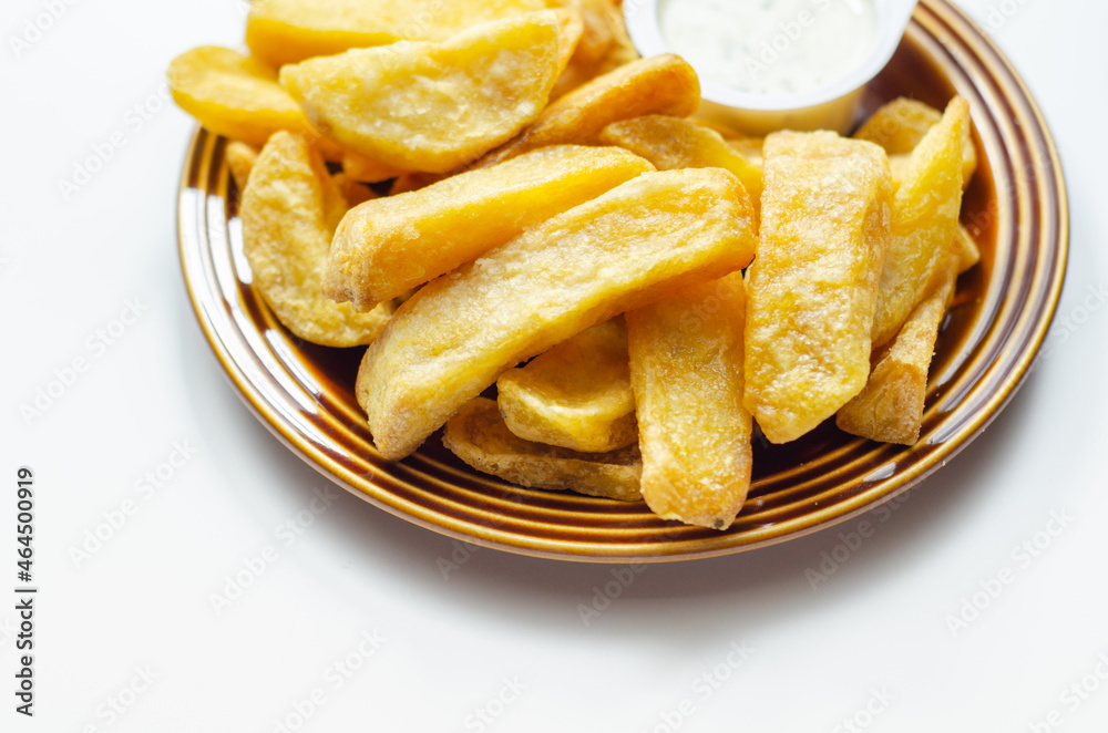 Deep fried and crispy delicious fries on the ceramic plate with garlic dip Deep fried and crispy delicious fries on the ceramic plate with garlic dip