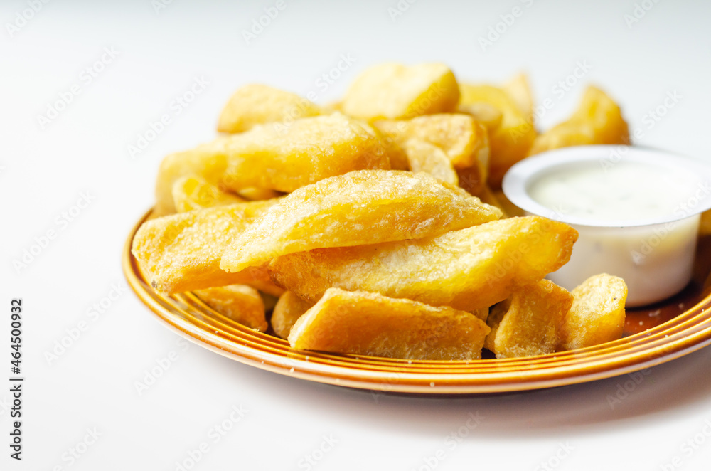 Deep fried and crispy delicious fries on the ceramic plate with garlic dip Deep fried and crispy delicious fries on the ceramic plate with garlic dip