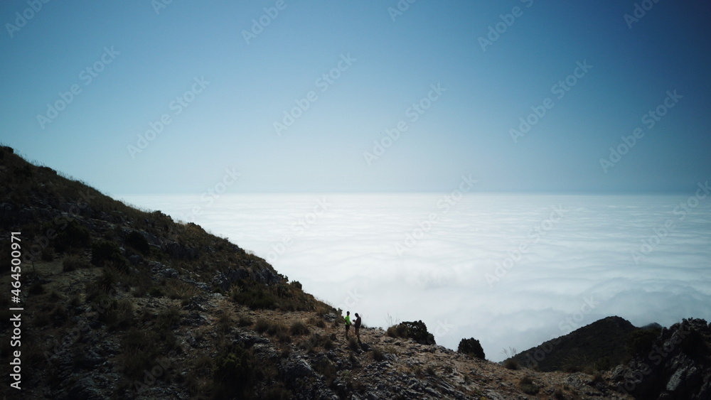 Friends hiking above cloud sea