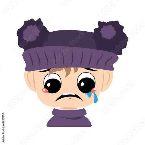 Child with crying and tears emotion, sad face, depressive eyes in violet hat with pom pom. Head of toddler with melancholy expression