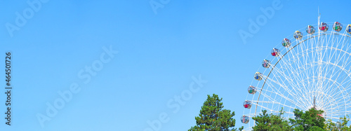 Attraction Ferris wheel on the background of blue sky, wide banner