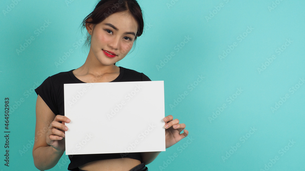 Asian woman hands is holding the A4 paper on MINT background. Asian woman hands is holding the A4 paper on MINT background.