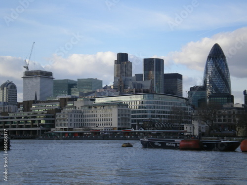 La ville de Londres avec ses bâtiments en pierre ou un peu en verre, avec une Tamise calme et plaine, ville sous un ciel bleu et avec un peu de nuages, vie et zone urbaine britannique © Nicolas Vignot