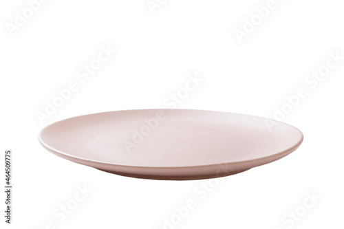 Pink ceramic round plate isolated over white background. perspective view © sosiukin