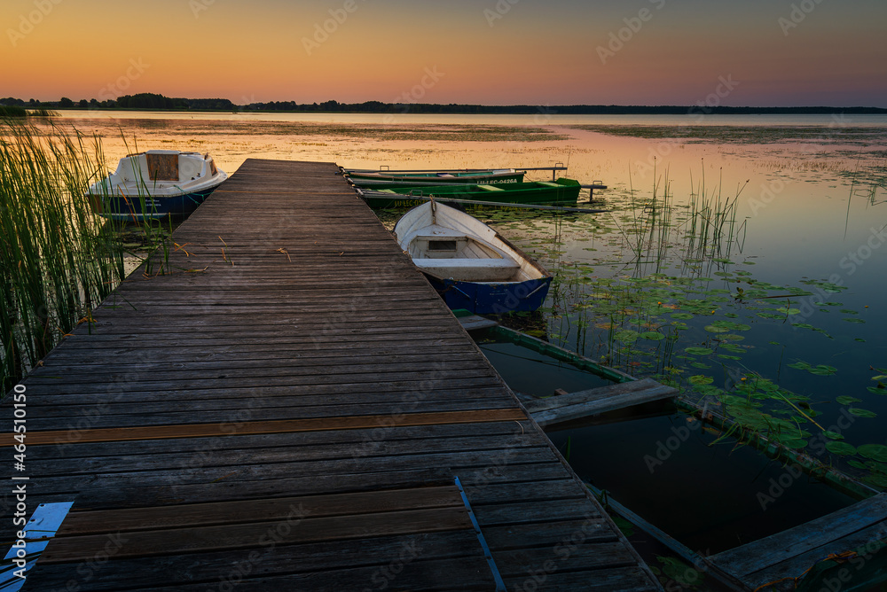 Fototapeta premium sunset on the lake and boat in wytyckie lake, poland lubelskie