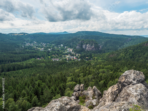 View from sandstone rock viewpoint Monchskanzeland on spruce tree forest, village Oybin and Zittauer Gebirge mountains nature park, summer landscape, Germany