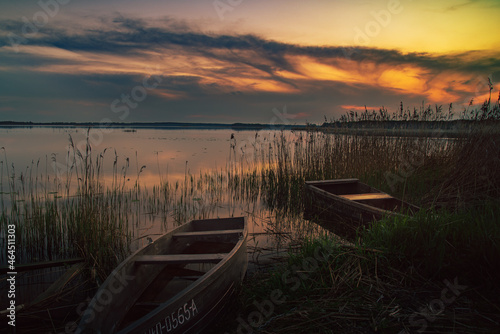 sunset on the lake and boat in wytyckie lake, poland lubelskie