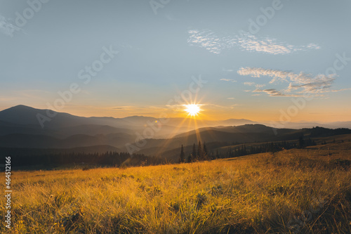 panorama of sunset in the mountains. sunbeams. rest on mountain tops. rays of the sun