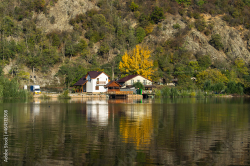 The house is located in a beautiful landscape, on the edge of the lake. The autumn. Reflections in the water.