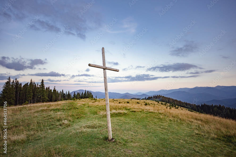 big wooden cross on top of the mountain. mountain landscape big wooden cross on top of the mountain. mountain landscape
