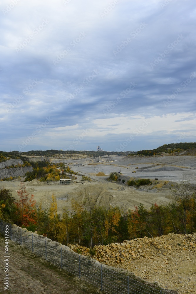 a large limestone quarry on an autumn day