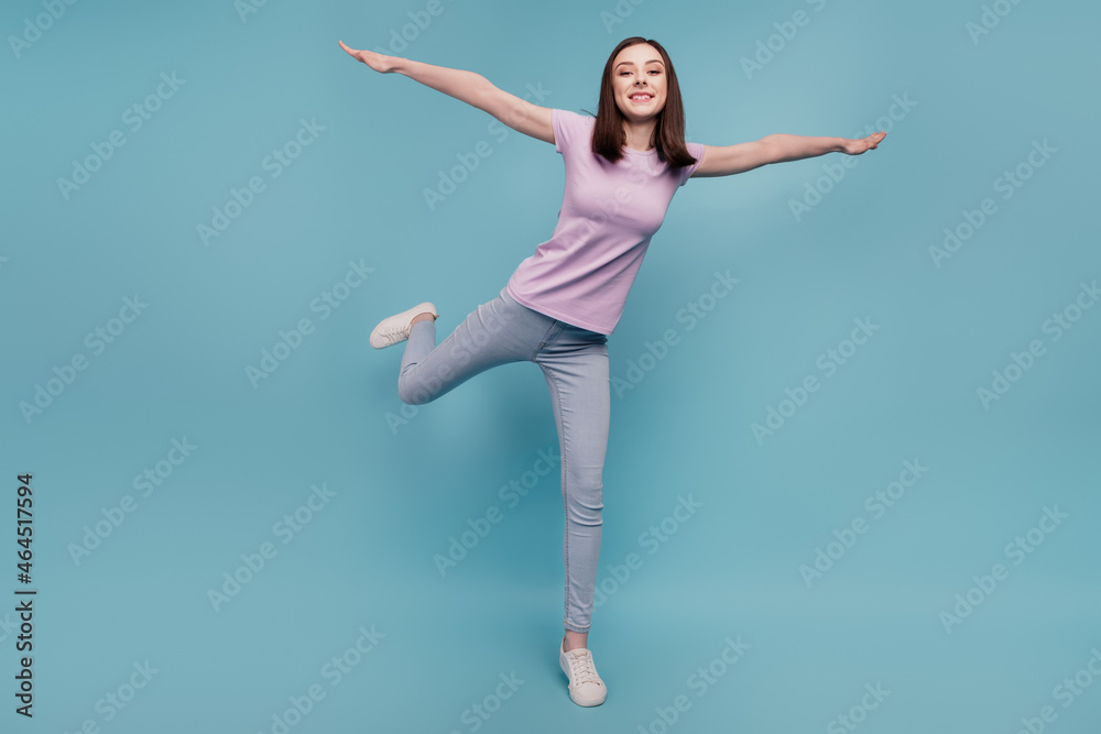 Full body photo of cheerful girl good mood hands wings fly plane casual outfit isolated over teal color background