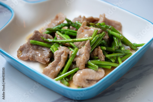 Asparagus sauteed with pork in a white ceramic dish