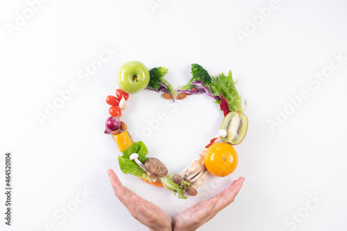 World food day, vegetarian day, Vegan day concept. Top view of woman hand covering fresh vegetables, fruit on white paper background.