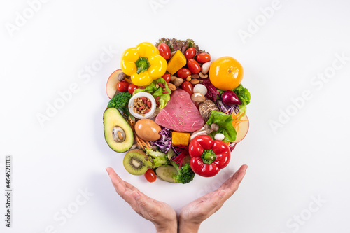 World food day, vegetarian day, Vegan day concept. Top view of woman hand covering fresh vegetables, fruit on white paper background.