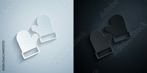 Paper cut Pair of knitted christmas mittens icon isolated on grey and black background. Mitten icon. Merry Christmas and Happy New Year. Paper art style. Vector