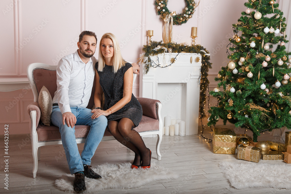 Beautiful happy couple in Christmas scenery Beautiful happy couple in Christmas scenery