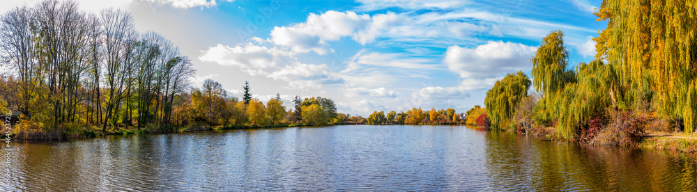 Fototapeta premium Panorama of autumn lake on a bright sunny day