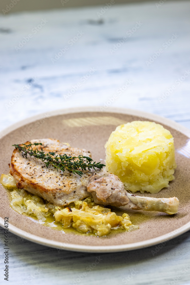 pork chop with thyme baked on creamy onion with mashed potatoes