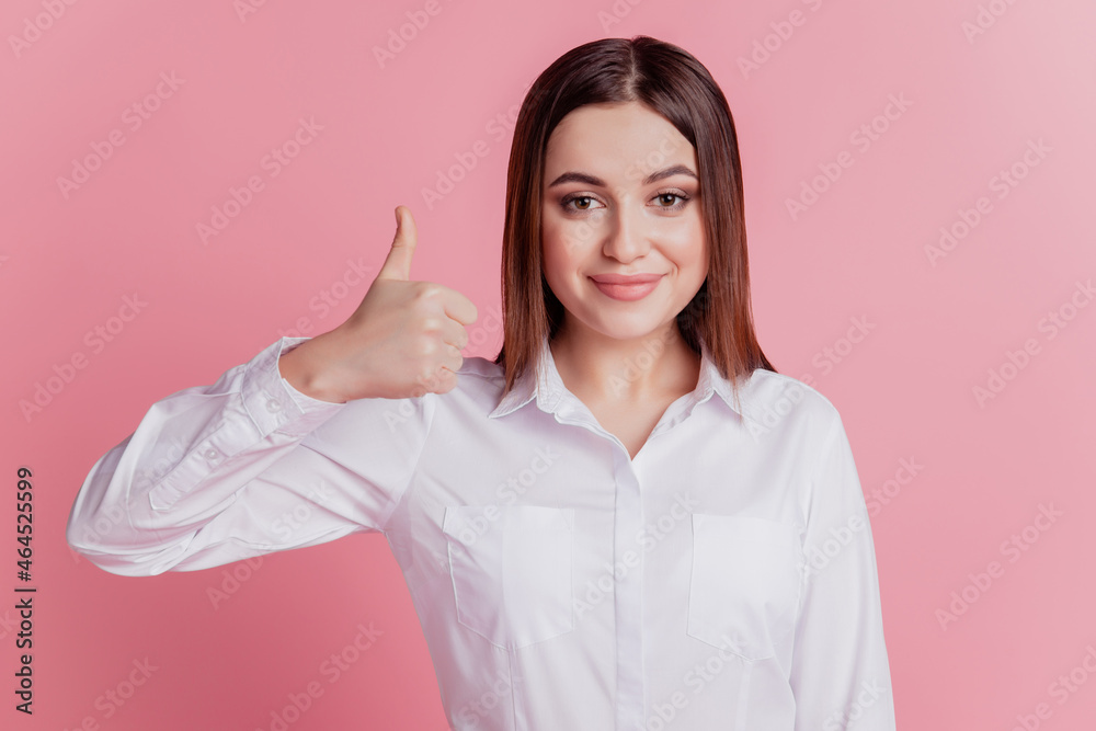 Photo of young attractive girl good mood show thumb-up fine recommend advertise isolated over pink color background Photo of young attractive girl good mood show thumb-up fine recommend advertise isolated over pink color background