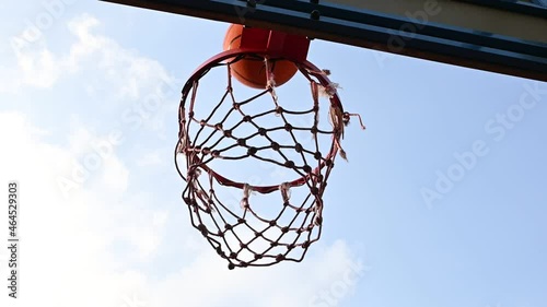 Shooting orange basketball ball into the basket