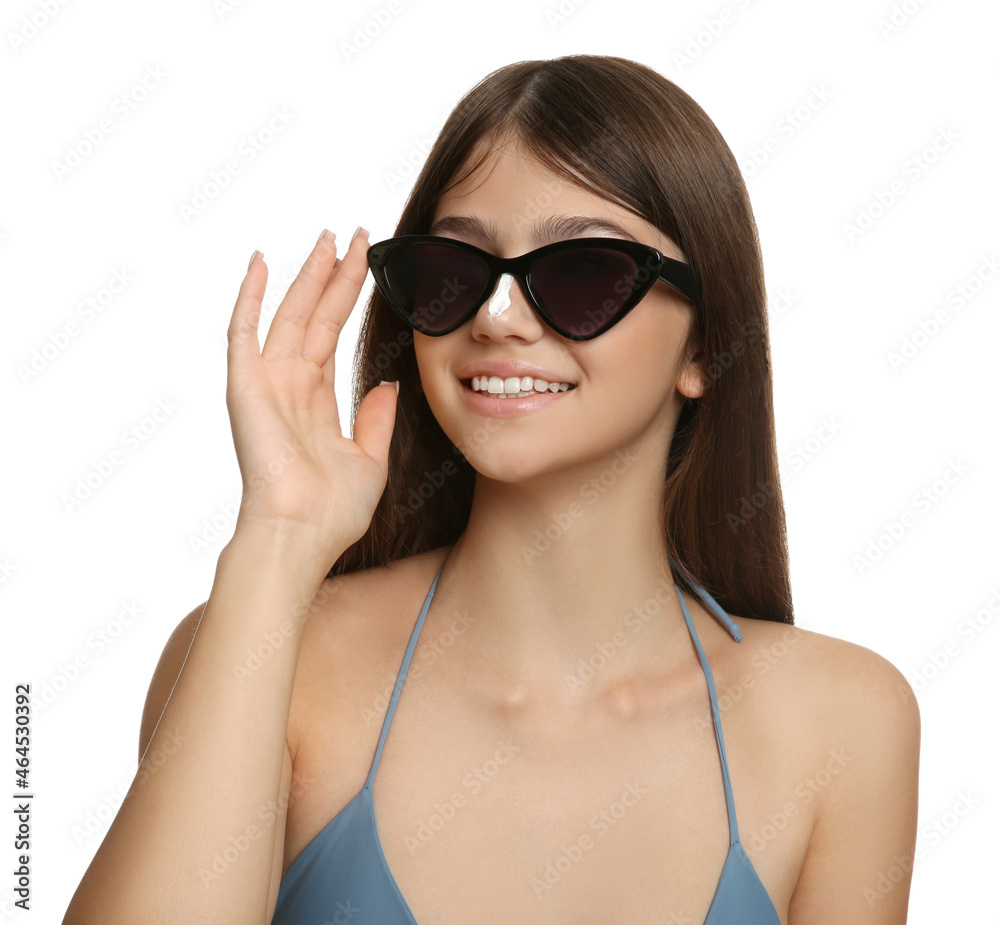 Teenage girl with sun protection cream on her nose against white background Teenage girl with sun protection cream on her nose against white background