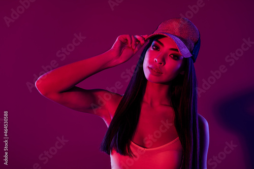 Portrait of attractive gorgeous girl posing touching hat isolated over shine purple violet color background