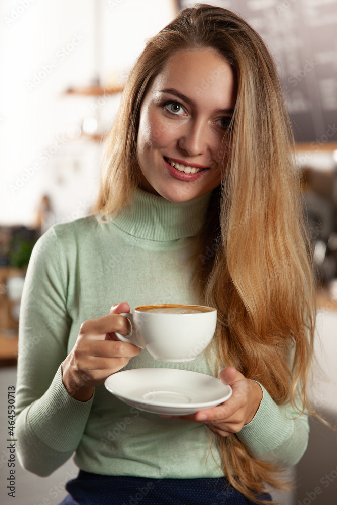 Beautiful girl in a cafe drinks coffee. Beautiful girl in a cafe drinks coffee.