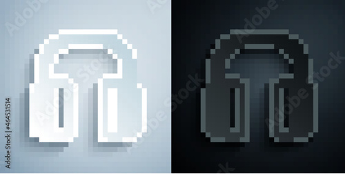 Paper cut Noise canceling headphones icon isolated on grey and black background. Headphones for ear protection from noise. Paper art style. Vector