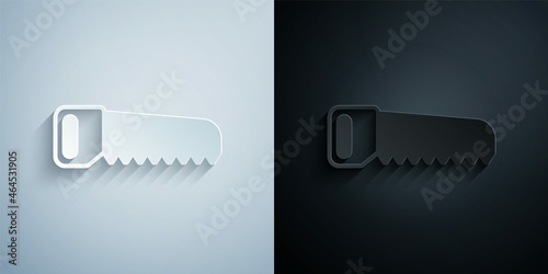 Paper cut Hand saw icon isolated on grey and black background. Paper art style. Vector