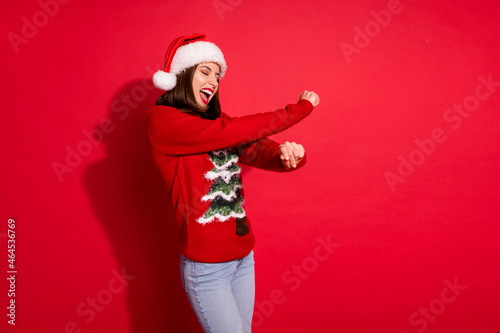 Photo of shiny charming young woman wear ornament sweater dancing enjoying noel party isolated red color background