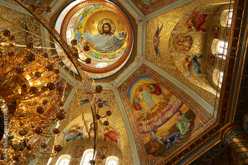 POCHAIV, UKRAINE -2021: Lavra Orthodox Christian Monastery Complex Transfiguration Cathedral Interior Cupola Ceiling Fresco of God Jesus Christ
