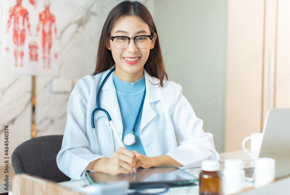 Portrait of young asian woman doctor with white coat standing in hospital.Telemedicine, Medical online, health concept. Doctor using laptop for work. Portrait of young asian woman doctor with white coat standing in hospital.Telemedicine, Medical online, health concept. Doctor using laptop for work.
