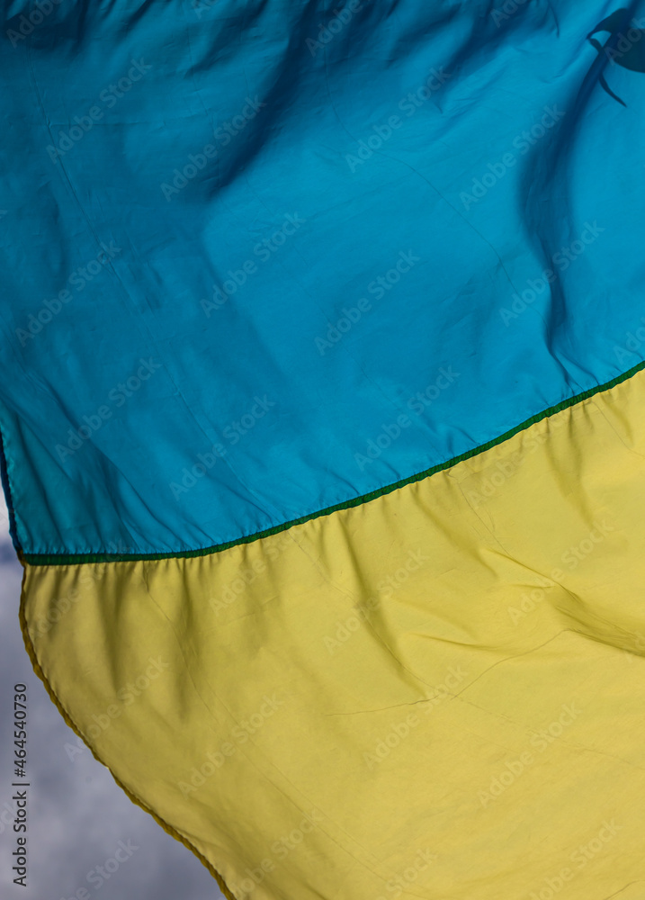 Ukraine flag waving on the wind against the blue sky