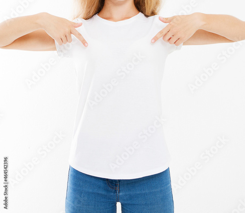 Attractive caucasian woman pointing with fingers to her blank white t-shirt isolated on white background