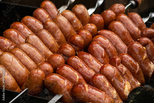 Sausages are roasted on the grill in the open air. Sausages are traditionally prepared at all gastronomic festivals. Very hearty and tasty dish. Street picture of food