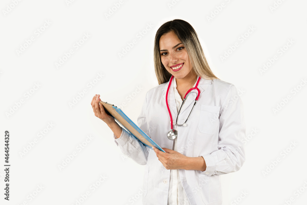 A young doctor reviewing a medical history with a smile. Concept of professional woman, health personnel. Medium shot, horizontal orientation. A young doctor reviewing a medical history with a smile. Concept of professional woman, health personnel. Medium shot, horizontal orientation.