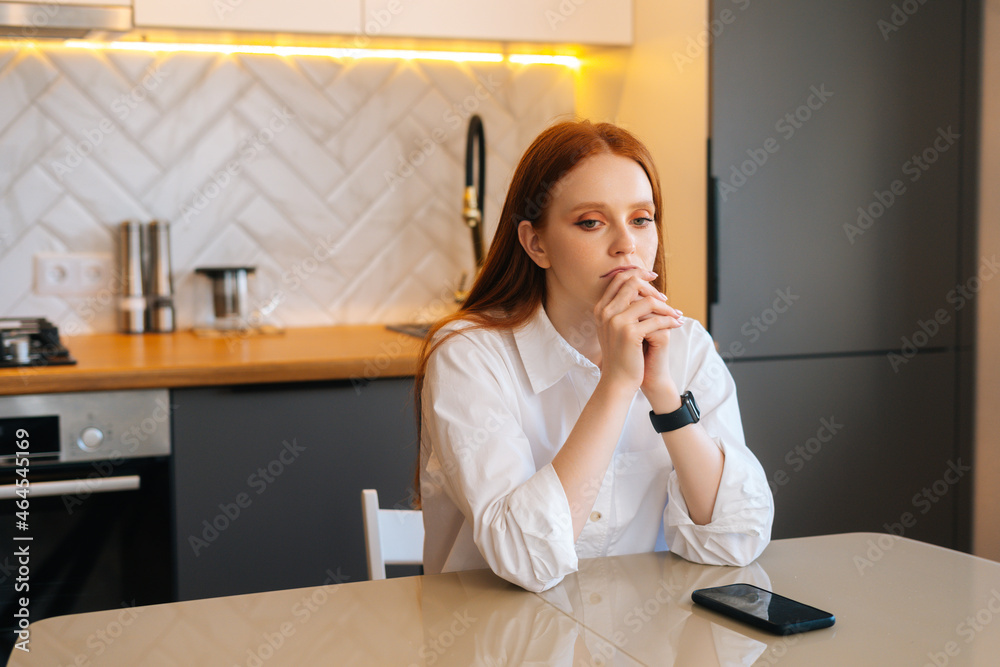 Portrait of faithful young woman praying holding folded hands in front of face at home, looking away. Depressed female put hands in prayer praying excitedly with hope, thinking about something. Portrait of faithful young woman praying holding folded hands in front of face at home, looking away. Depressed female put hands in prayer praying excitedly with hope, thinking about something.