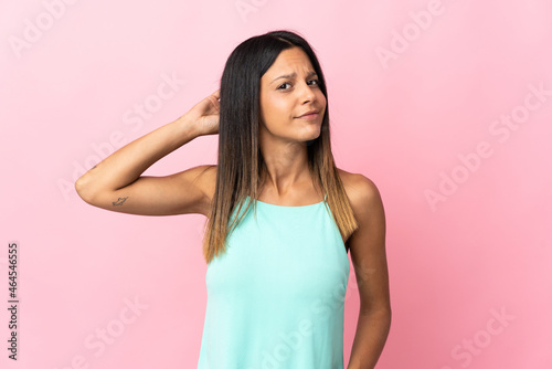 Caucasian girl isolated on pink background having doubts