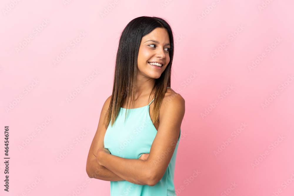 Caucasian girl isolated on pink background looking to the side and smiling Caucasian girl isolated on pink background looking to the side and smiling