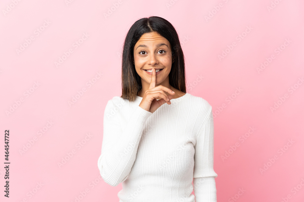Caucasian girl isolated on pink background showing a sign of silence gesture putting finger in mouth Caucasian girl isolated on pink background showing a sign of silence gesture putting finger in mouth