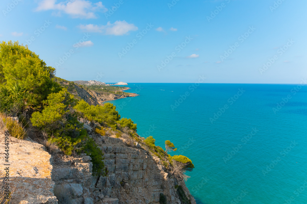 Rocky Coastal Mountain With Greenery And Historic Badum Tower In Peniscola, Spain. - wide shot.