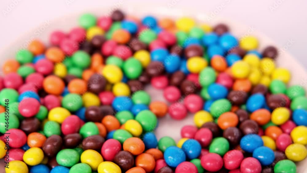 Frankfurt, Germany, October 2021: close-up of multi-colored button-shaped chocolates, each of which has letter 