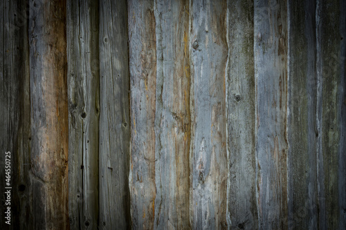 Wooden logs of an old house. Close-up. Weathered natural gray wood texture. Background. Horizontal photo.